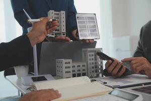 Team of architectures and businessman are discussing and brainstorming on floor plan modification for real estate sustainable investment and solar energy housing development project photo