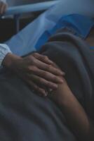 Cropped shot of a female nurse hold her senior patient's hand. Giving Support. Doctor helping old patient with Alzheimer's disease. Female carer holding hands of senior man photo