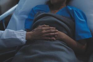 Cropped shot of a female nurse hold her senior patient's hand. Giving Support. Doctor helping old patient with Alzheimer's disease. Female carer holding hands of senior man photo