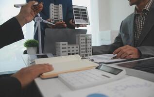 Team of architectures and businessman are discussing and brainstorming on floor plan modification for real estate sustainable investment and solar energy housing development project photo