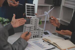 Team of architectures and businessman are discussing and brainstorming on floor plan modification for real estate sustainable investment and solar energy housing development project photo