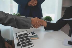 Construction workers holding helmets and vests are shaking hands. real estate concept Architect shaking hands with engineer or builder planning and successful meetings photo