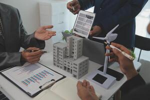 Team of architectures and businessman are discussing and brainstorming on floor plan modification for real estate sustainable investment and solar energy housing development project photo