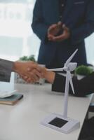 Construction workers holding helmets and vests are shaking hands. real estate concept Architect shaking hands with engineer or builder planning and successful meetings photo