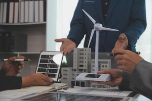 Team of architectures and businessman are discussing and brainstorming on floor plan modification for real estate sustainable investment and solar energy housing development project photo