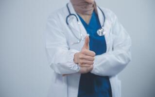 Doctor wearing white coat and watching patient data in Tablet . photo