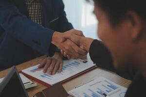 Estate agent shaking hands with customer after contract signature photo