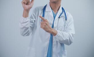 Mature male doctor with tablet pc is giving presentation. Blurred background indoors. photo