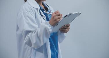 Woman doctor using tablet computer while standing straight in hospital photo