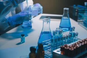 chemist,scientist hand dropping chemical liquid into test tube, science research and development concept photo