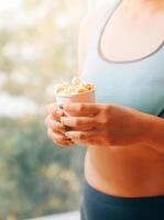 A woman holding a bowl of popcorn photo