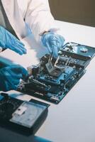 Close up of Technician measuring voltage electronic circuit board television, Service after sale fix electric equipment within insurance. photo