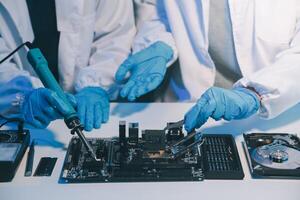 Close up of Technician measuring voltage electronic circuit board television, Service after sale fix electric equipment within insurance. photo