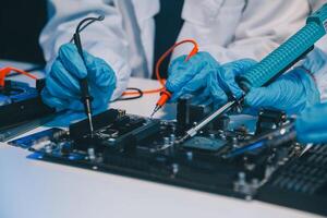 Close up of Technician measuring voltage electronic circuit board television, Service after sale fix electric equipment within insurance. photo