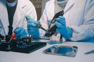 Close up of Technician measuring voltage electronic circuit board television, Service after sale fix electric equipment within insurance. photo