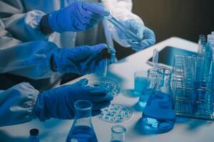 chemist,scientist hand dropping chemical liquid into test tube, science research and development concept photo