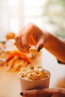 A woman holding a bowl of popcorn photo