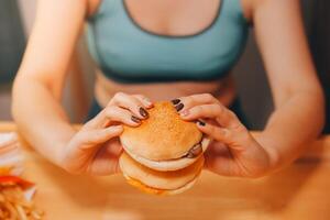 Binge eating disorder concept with woman eating fast food burger, fired chicken , donuts and desserts photo