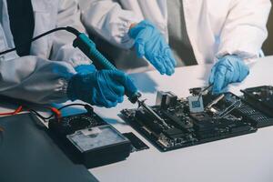 Close up of Technician measuring voltage electronic circuit board television, Service after sale fix electric equipment within insurance. photo