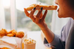 Cropped image of woman holding pizza slice at restaurant photo