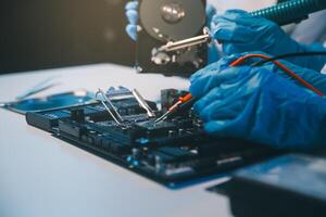 Close up of Technician measuring voltage electronic circuit board television, Service after sale fix electric equipment within insurance. photo