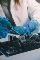 Close up of Technician measuring voltage electronic circuit board television, Service after sale fix electric equipment within insurance. photo