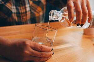 healthy beautiful young woman holding glass of water photo