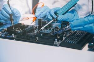 Close up of Technician measuring voltage electronic circuit board television, Service after sale fix electric equipment within insurance. photo