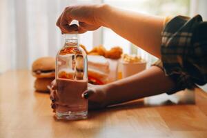 healthy beautiful young woman holding glass of water photo