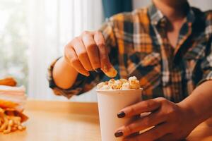 A woman holding a bowl of popcorn photo