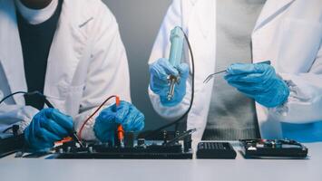 Close up of Technician measuring voltage electronic circuit board television, Service after sale fix electric equipment within insurance. photo