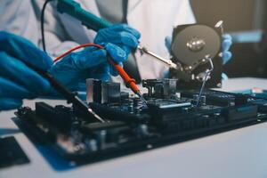 Close up of Technician measuring voltage electronic circuit board television, Service after sale fix electric equipment within insurance. photo