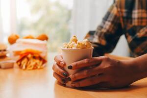 A woman holding a bowl of popcorn photo