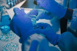 chemist,scientist hand dropping chemical liquid into test tube, science research and development concept photo