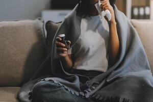 Upset woman frustrated by problem with work or relationships, sitting on couch, embracing knees, covered face in hand, feeling despair and anxiety, loneliness, having psychological trouble photo