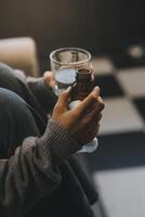 Upset woman frustrated by problem with work or relationships, sitting on couch, embracing knees, covered face in hand, feeling despair and anxiety, loneliness, having psychological trouble photo