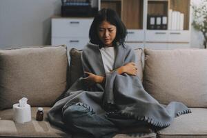 Upset woman frustrated by problem with work or relationships, sitting on couch, embracing knees, covered face in hand, feeling despair and anxiety, loneliness, having psychological trouble photo