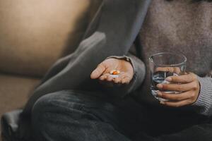 Upset woman frustrated by problem with work or relationships, sitting on couch, embracing knees, covered face in hand, feeling despair and anxiety, loneliness, having psychological trouble photo