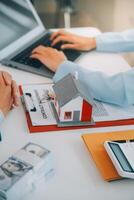 Real estate agent talked about the terms of the home purchase agreement and asked the customer to sign the documents to make the contract legally, Home sales and home insurance concept. photo