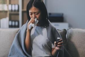 Upset woman frustrated by problem with work or relationships, sitting on couch, embracing knees, covered face in hand, feeling despair and anxiety, loneliness, having psychological trouble photo