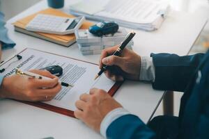 Insurance officers hand over the car keys after the tenant. have signed an auto insurance document or a lease or agreement document Buying or selling a new or used car with a car photo