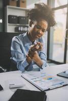 Asian woman working hard in the office having aches and pains in her torso and waist photo