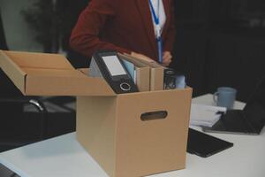 Businesswoman packing her things for move photo