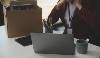 Businesswoman packing her things for move photo