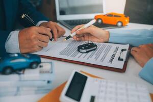Insurance officers hand over the car keys after the tenant. have signed an auto insurance document or a lease or agreement document Buying or selling a new or used car with a car photo