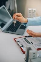 Real estate agent talked about the terms of the home purchase agreement and asked the customer to sign the documents to make the contract legally, Home sales and home insurance concept. photo