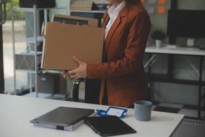 Businesswoman packing her things for move photo