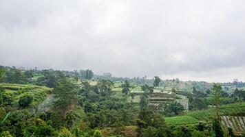 hill landscape with various farms photo