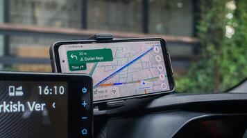 application,using google maps on a smartphone in a car. semarang, 9 April 2024. photo