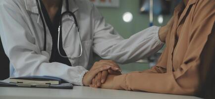 Hand of doctor reassuring her female patient photo